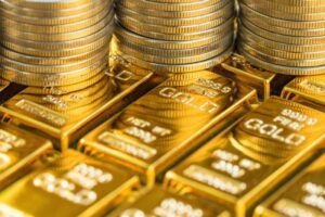 gold coins on top of gold bars