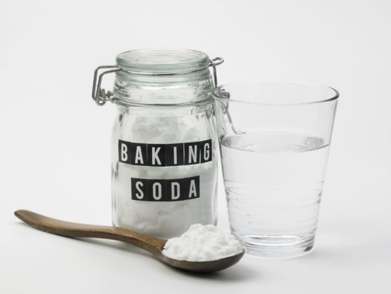 jar or baking soda cup of water and spoon with baking soda jar or baking soda cup of water and spoon with baking soda