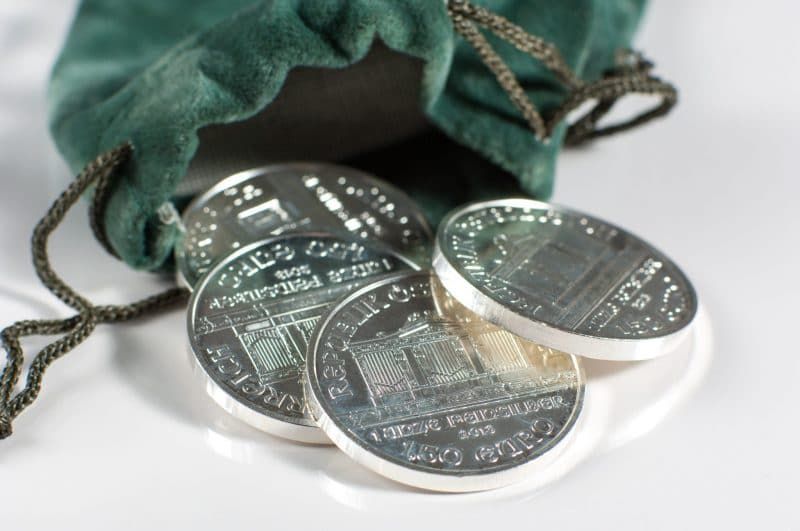 silver coins on a green bag