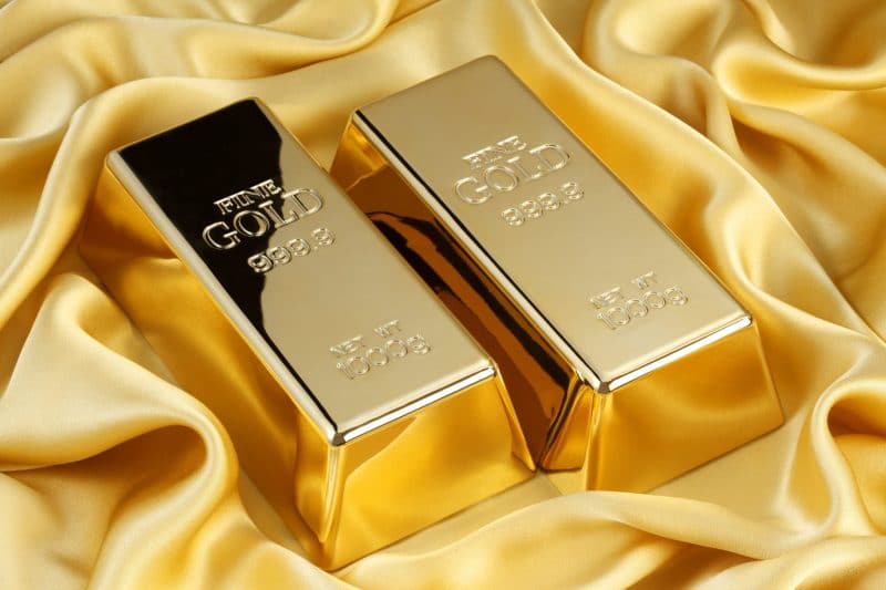two gold bars on a gold silk cloth two gold bars on a gold silk cloth
